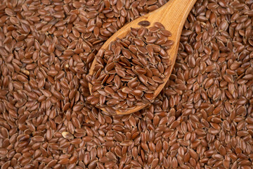 Close up of brown flax seeds background, top view, studio shot
