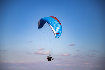 glider paragliding g against blue sky flying  adrenaline and freedom concept