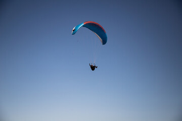 glider paragliding g against blue sky flying  adrenaline and freedom concept