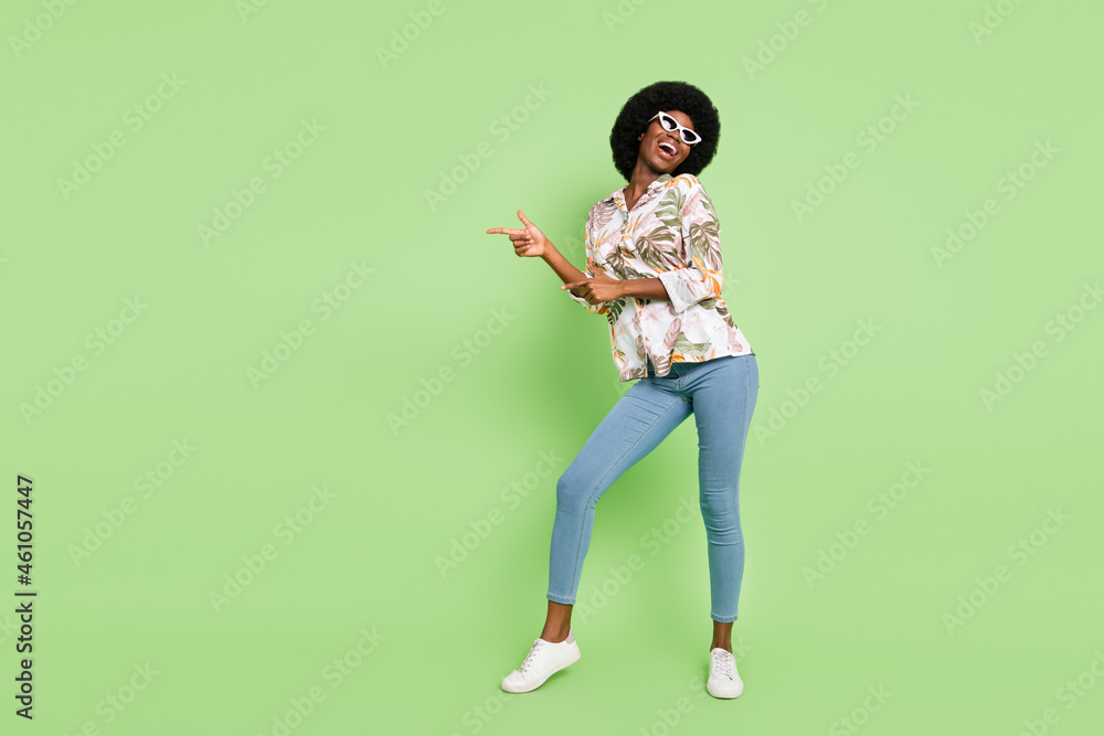 Poster Full body photo of young cheerful afro girl happy positive smile point fingers empty space dancer isolated over green color background