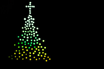 christmas tree isolated on black background with colorful blurred lights. Merry Christmas. Abstract.