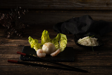 Steamed pork and prawn dim sum on slate stone on wooden table