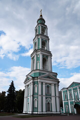View of the bell tower of the Transfiguration Cathedral. Bell tower on a background of clouds.