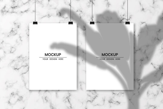 Blank hanging white papers with white marble background and shadow overlay effect