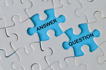 Top view of jigsaw puzzle with text ANSWER and QUESTION