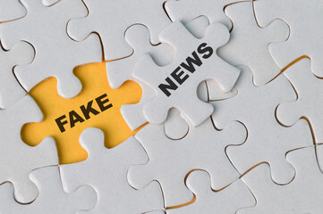 Fototapeta premium Top view of jigsaw puzzle with text FAKE NEWS