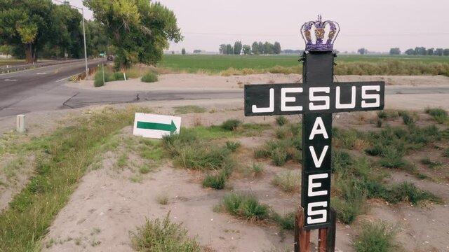 Aerial: Road sign cross in the countryside with Jesus Saves. Yerington, Nevada