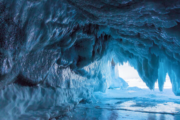 Winter Baikal. The fantastic beauty of the grottoes, framed by numerous transparent icicles. Natural winter background - 461060882