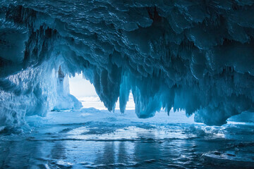Winter Baikal. The fantastic beauty of the grottoes, framed by numerous transparent icicles. Natural winter background