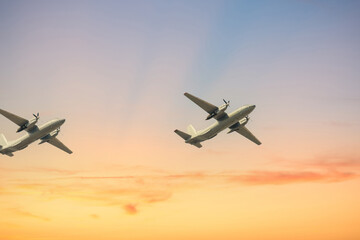 Two planes flights propeller jets on blue sky with clouds