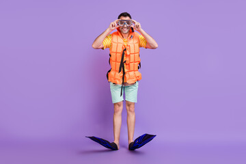 Full length photo of happy positive man wear vest glasses diver equipment swim isolated on purple color background