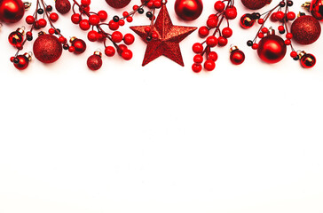 White Christmas and New Year background with red Christmas balls, big star and berries, top view, copy spase