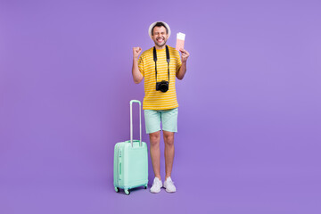 Full length body size photo man in hat keeping bags tickets won trip isolated pastel violet color background