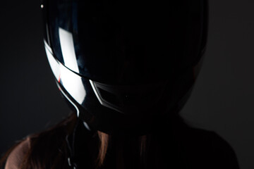 Naklejka na ściany i meble young woman standing with motorcycle helmet
