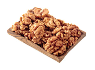 Walnuts in wooden dish isolated on  white.