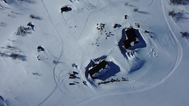 Bird's Eye View Of STF Unna Allakas, Mountain Cabin In Sweden During Winter - aerial drone shot