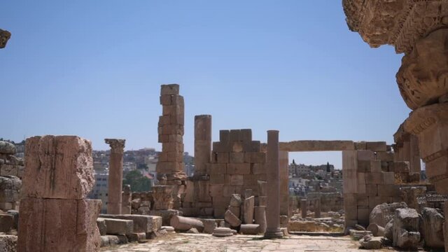Remains of Ancient Roman Gerasa City, Jerash, Jordan, Stone Columns Under Clear Blue Sky, Tilt Down