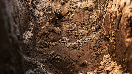 Texture layers of earth. Cross section of brown underground soil layers beneath. Natural cut of...