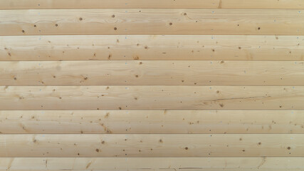 Block house texture. Wood texture background. A planed board of the lining type, made in the form of a segment of a rounded log or a profiled bar. Designed for interior and exterior decoration