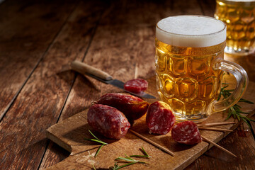Tasty spicy mini salami served with a cold tankard of beer