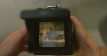 Person open top cover of vintage medium format camera, adjust focus and exposure to make photo. Film photography enthusiast, exciting photo hobby, use analog retro camera to capture memories