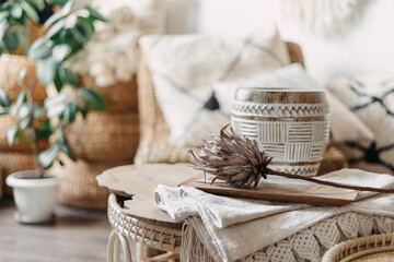 Protea flower on rattan bamboo table in room