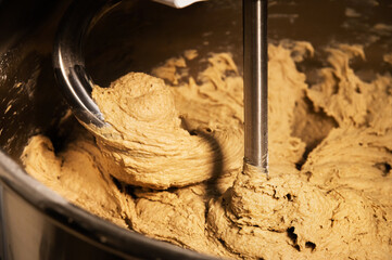The kneading machine kneads the dough for baking artisan bread.