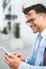 Handsome businessman using a mobile app