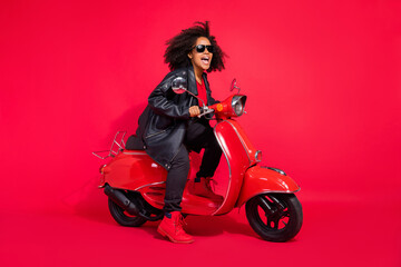 Fototapeta na wymiar Full size profile photo of attractive overjoyed girl driving moped trip journey isolated on red color background