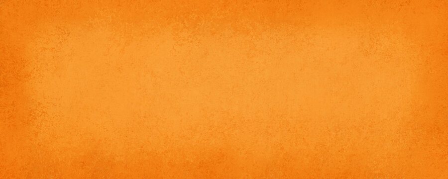 Orange background for halloween or fall with old vintage texture grunge borders, hot vibrant orange color paper, autumn or thanksgiving background colors
