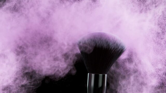 Super slow motion of makeup brush with exploding purple powder. Filmed on high speed cinema camera, 1000fps.