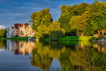 Fototapeta na wymiar Typical architecture of houses that are reflected on the Danube illuminated by the light of the sunset. Ulm, Tübingen, Donau-Iller region, Germany, Europe