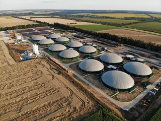 Modern bio comlex. Renewable energy from biomass. Innovative biogas plant among green nature. Aerial view.