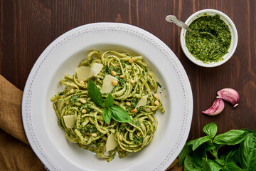 Classic italian pasta pesto with pine nuts, pound garlic, basil leaves, hard parmesan cheese and...
