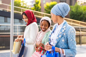 Beautiful muslim girl wearing hijab bonding outdoors