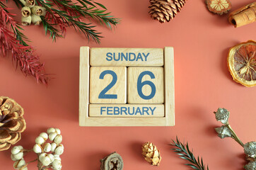 February 26, Cover design with calendar cube, pine cones and dried fruit in the natural concept.