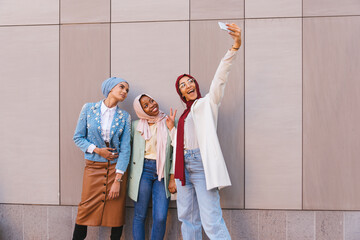 Beautiful muslim girl wearing hijab bonding outdoors