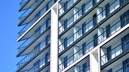 Modern apartment building. Modern urban architecture and details of building facade. Sunlight.