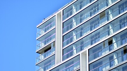 Modern apartment building. Modern urban architecture and details of building facade. Sunlight.