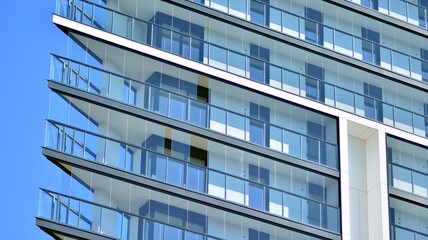 Modern apartment building. Modern urban architecture and details of building facade. Sunlight.