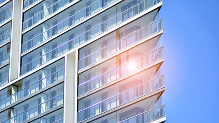 Modern apartment building. Modern urban architecture and details of building facade. Sunlight.