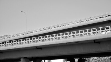 Bridge against the blue sky. Motorway flyover. Elevated roads on sunny day.