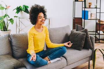 Afro american girl relaxing at home with yoga meditation