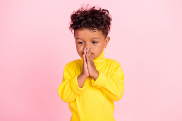Photo of focused dark skin pupil hands palms together imagine deep isolated on pink color background
