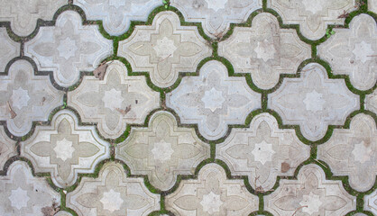 White tile stones floor with grass