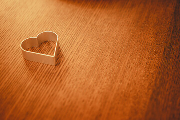 Metal heart shape on a brown wooden vintage table in rustic style, metallic, valentines day, wooden...