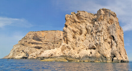 Limestone cliffs of the Capo Caccia cape at the Gulf of Alghero, Sardinia, Italy
