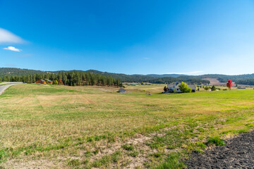 Farms, homes and ranches amid the rolling hills of the Green Bluff area of Spokane, Washington, USA, as leaves start to turn colors at autumn.