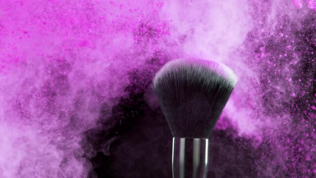 Super slow motion of makeup brush with exploding purple powder. Filmed on high speed cinema camera, 1000fps.