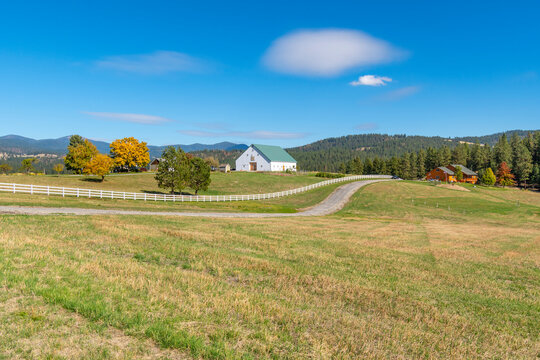 Farms, homes and ranches amid the rolling hills of the Green Bluff area of Spokane, Washington, USA, as leaves start to turn colors at autumn.